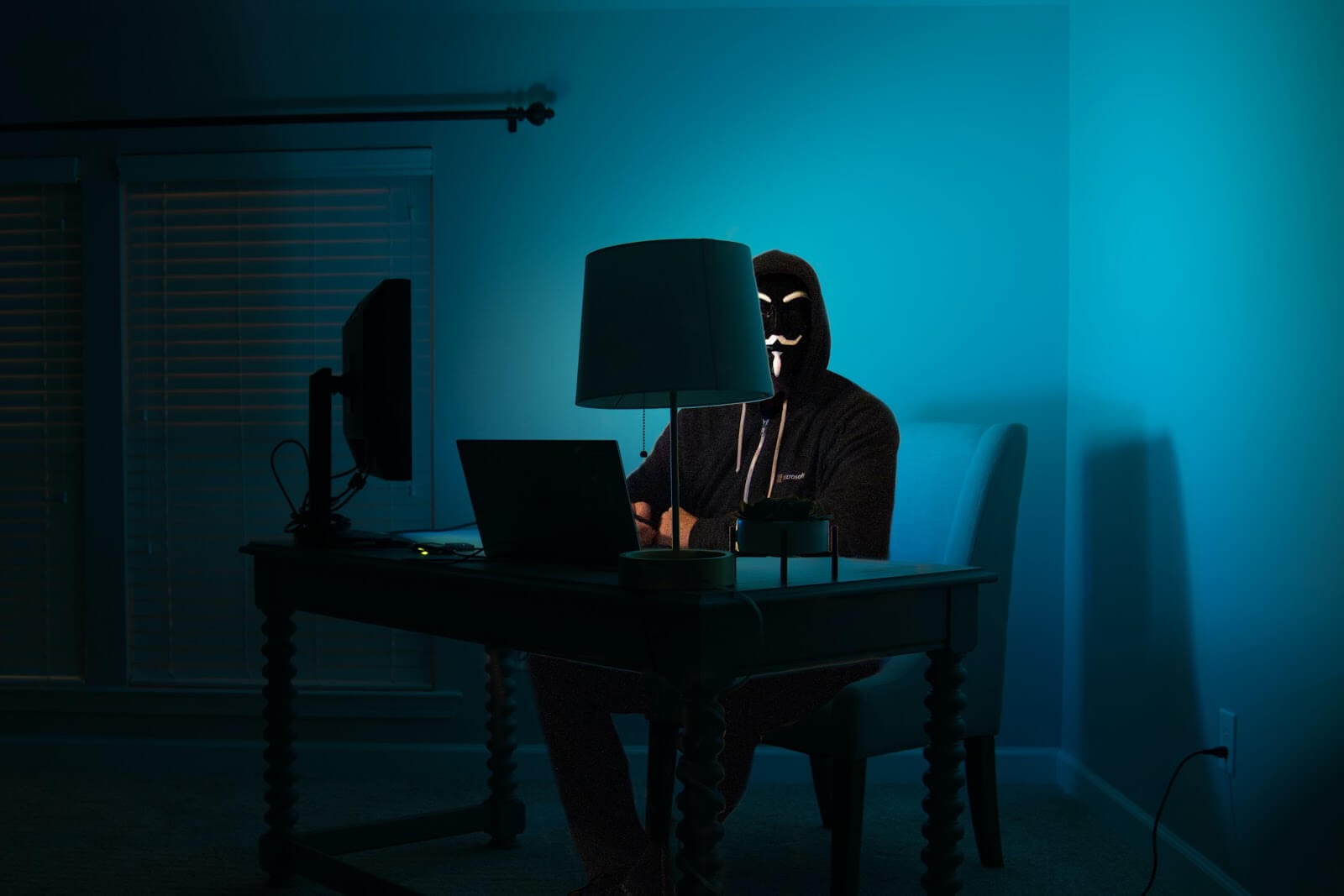 a man in a mask on a computer