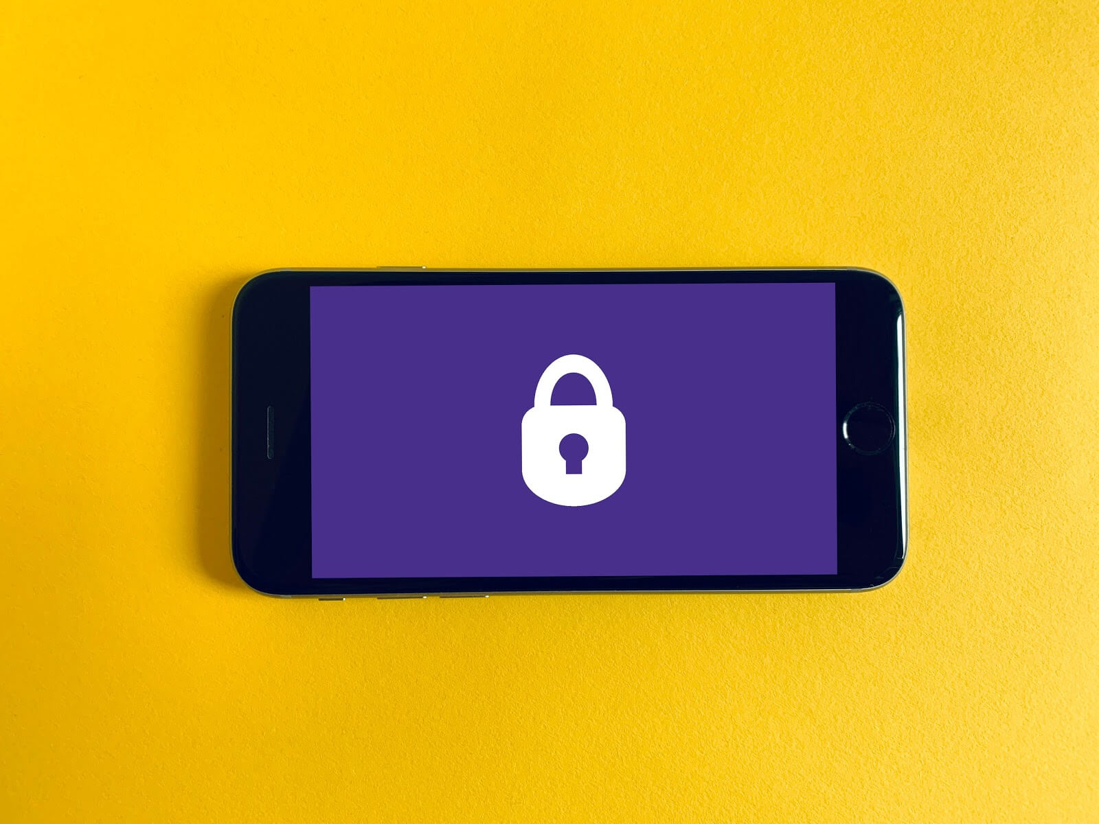 a yellow background with a purple cell phone