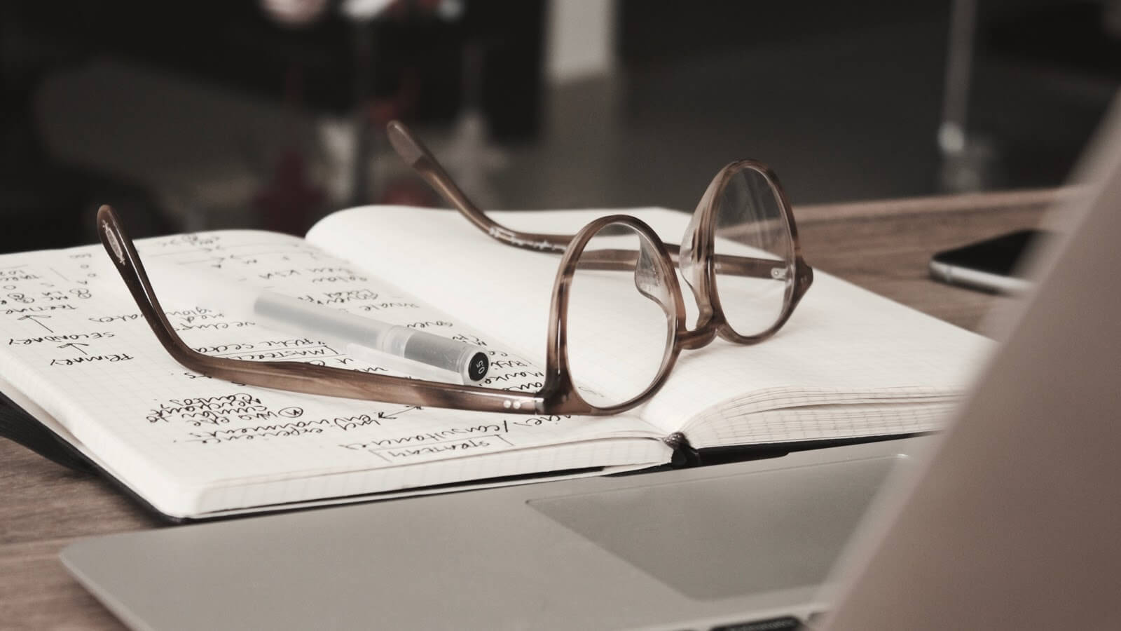 glasses sitting on a pile of documents